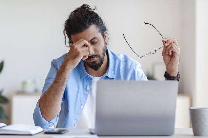 Business owner looking at his laptop with a distraught face