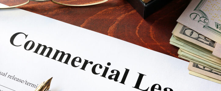 Commercial lease document on a wooden table.