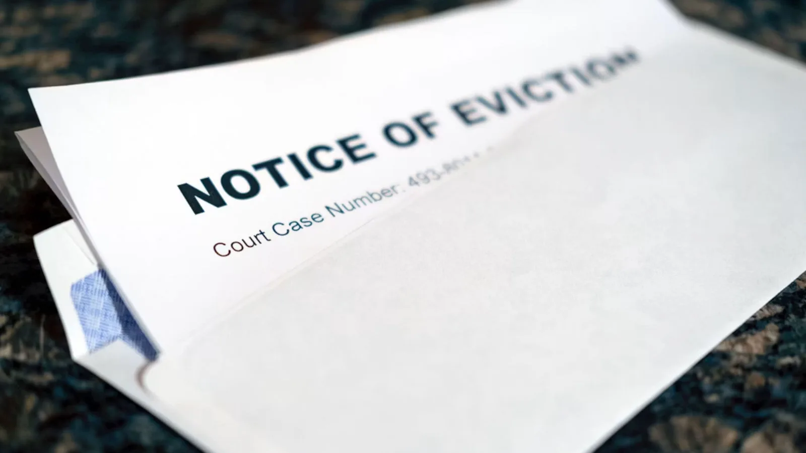 A letter sticking out of an envelope that says "Notice of Eviction"