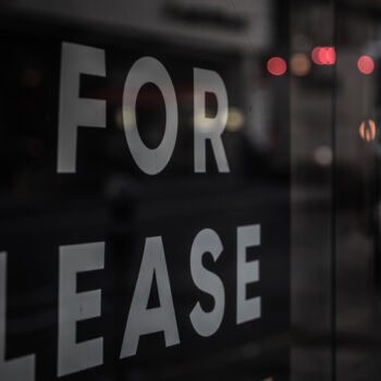 "For Lease" sign on a glass door