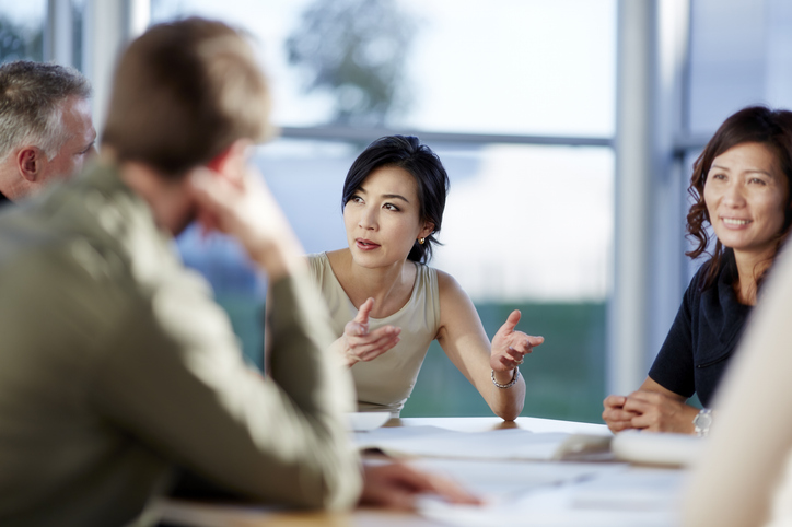 Korean businesswomen talking with American businessmen