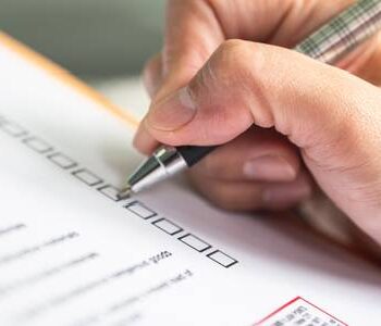 Woman writing on the OSHA checklist