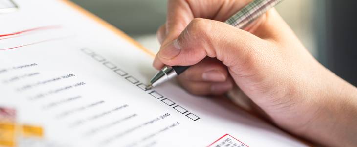 Woman writing on the OSHA checklist