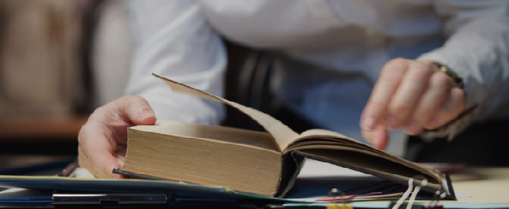 Employee flipping through her handbook