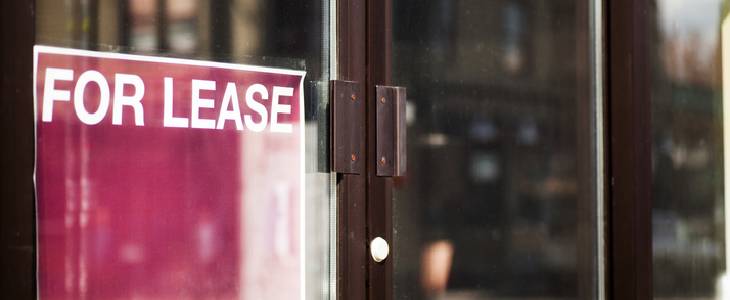 FOR LEASE sign in the front of a store