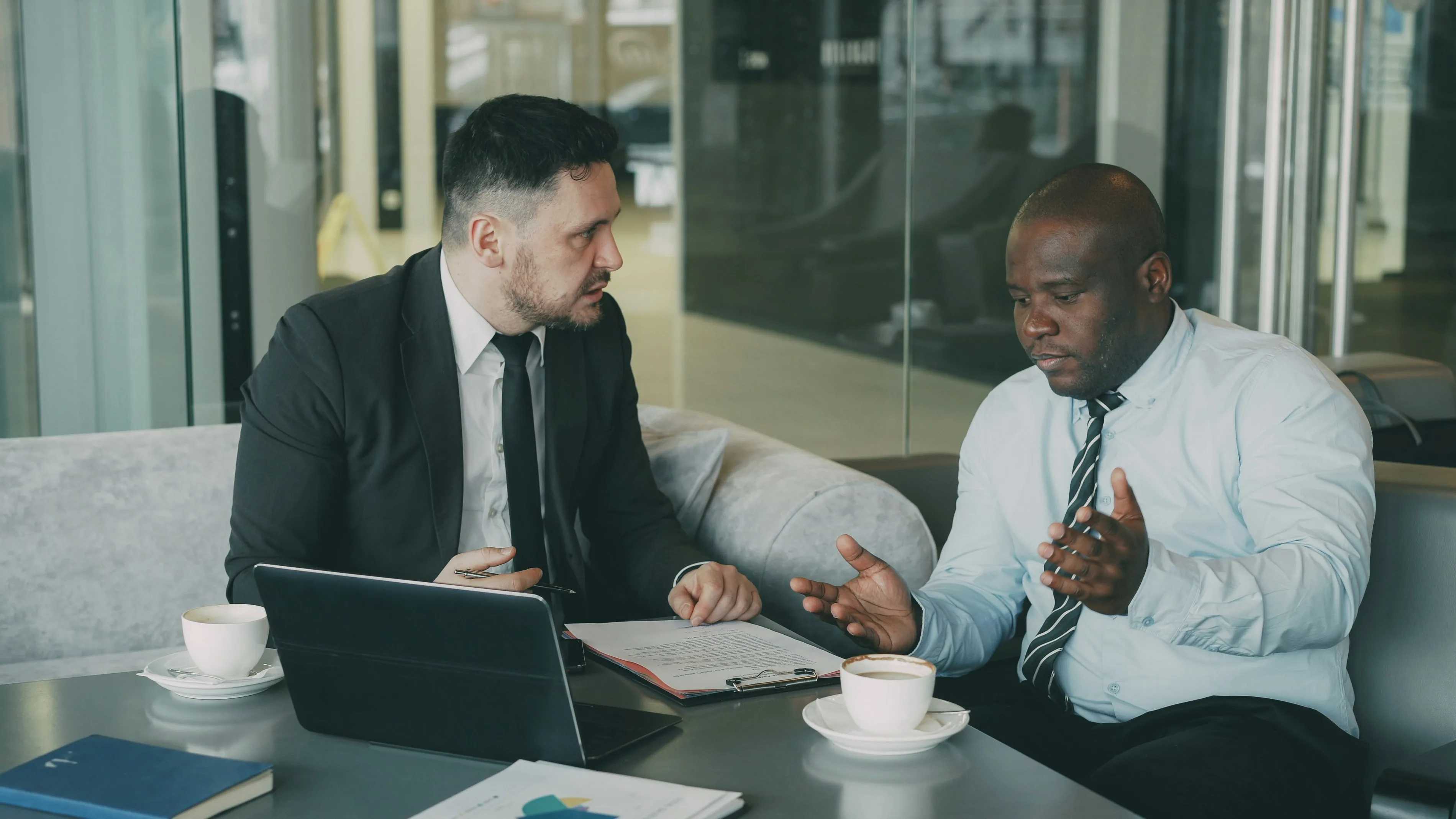 Two business men arguing while looking at a laptop