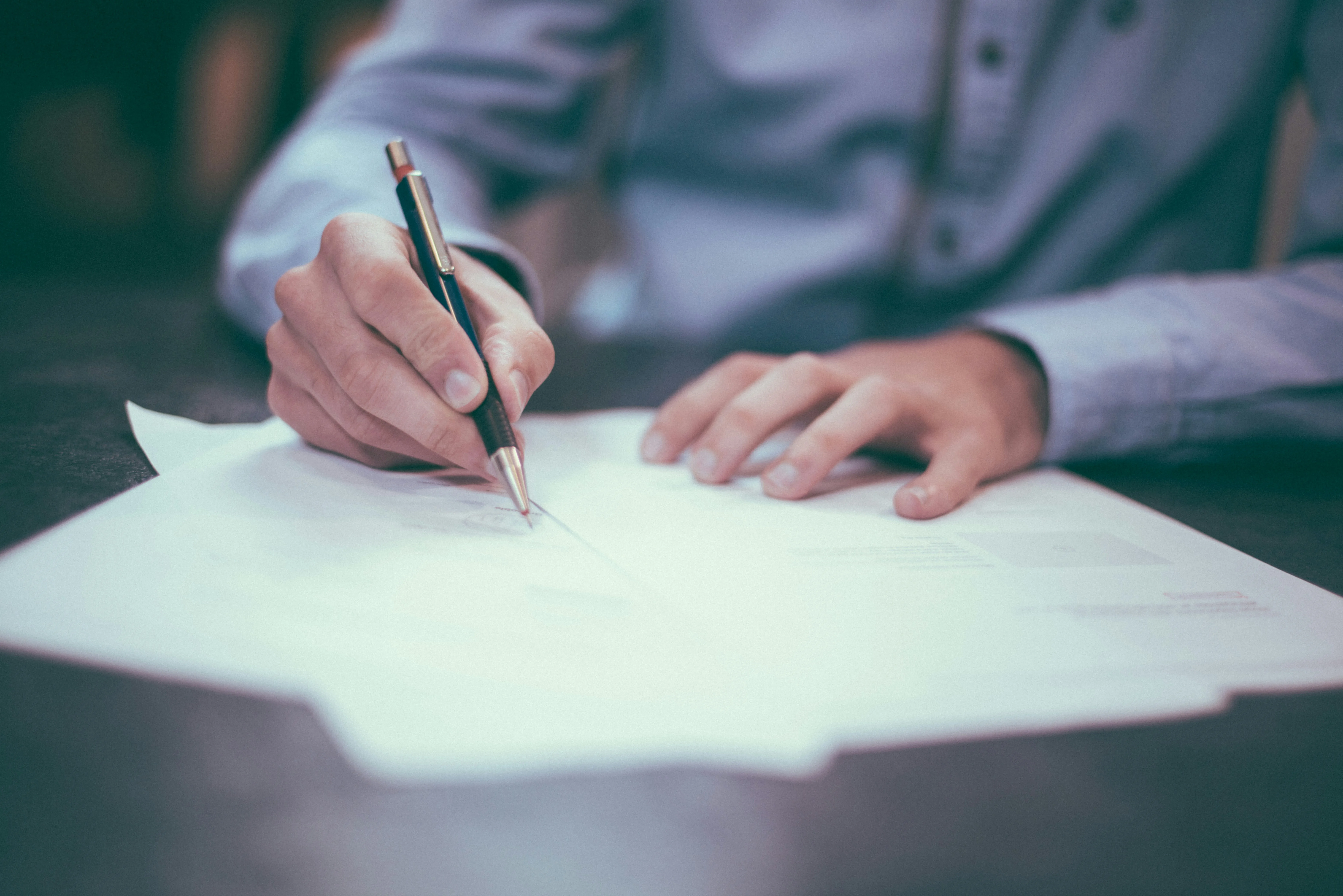Someone signing a contract