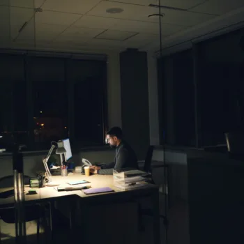A man working at his desk at night