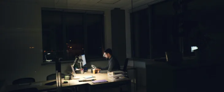 A man working at his desk at night