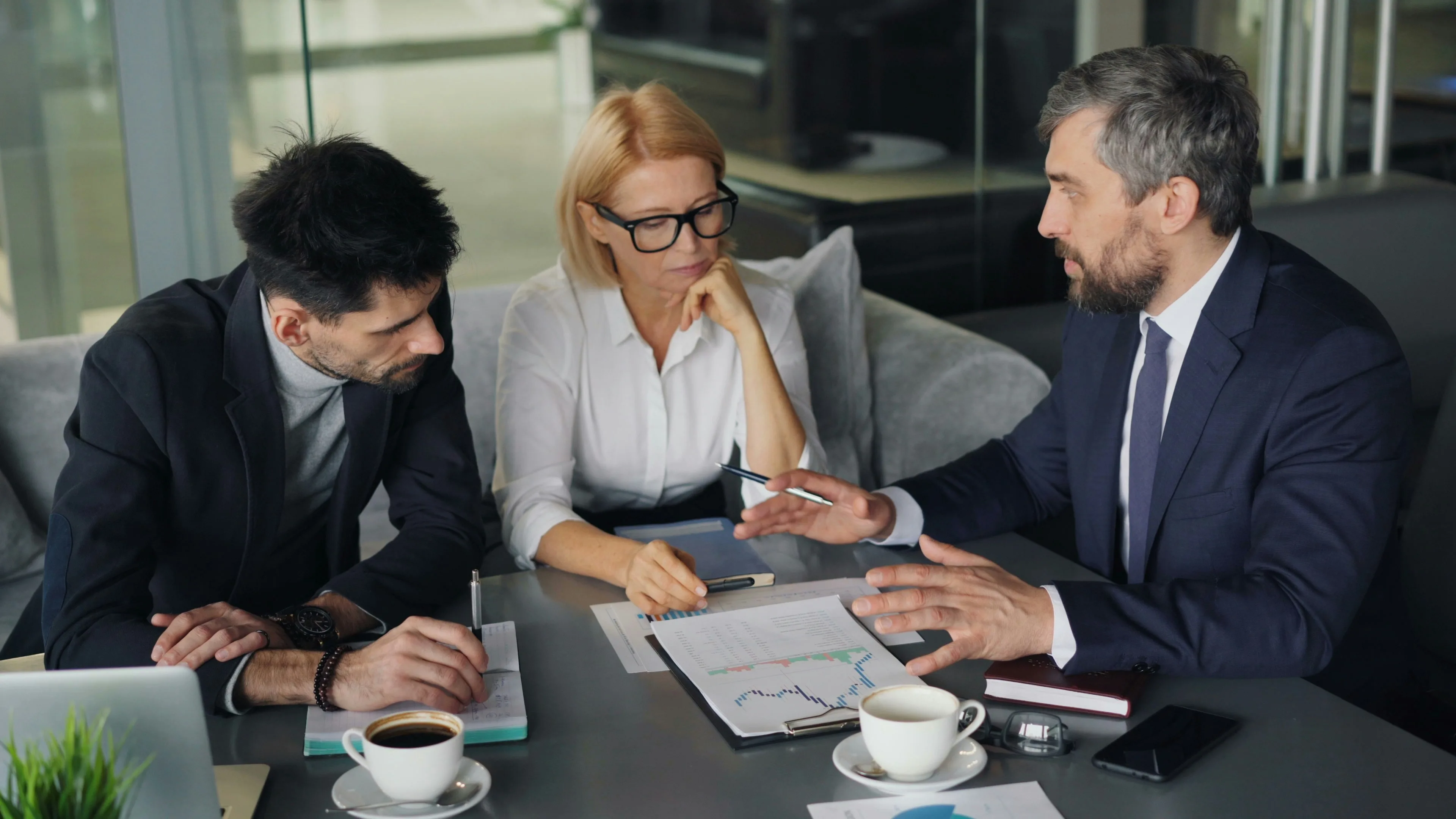 A business meeting at a table with three workers