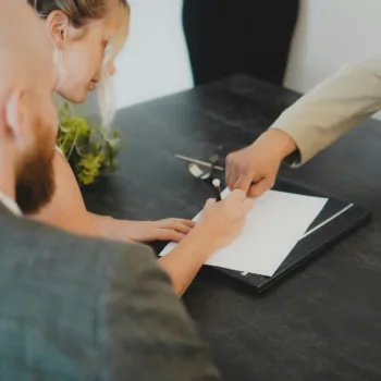 A man showing someone where to sign on a contract