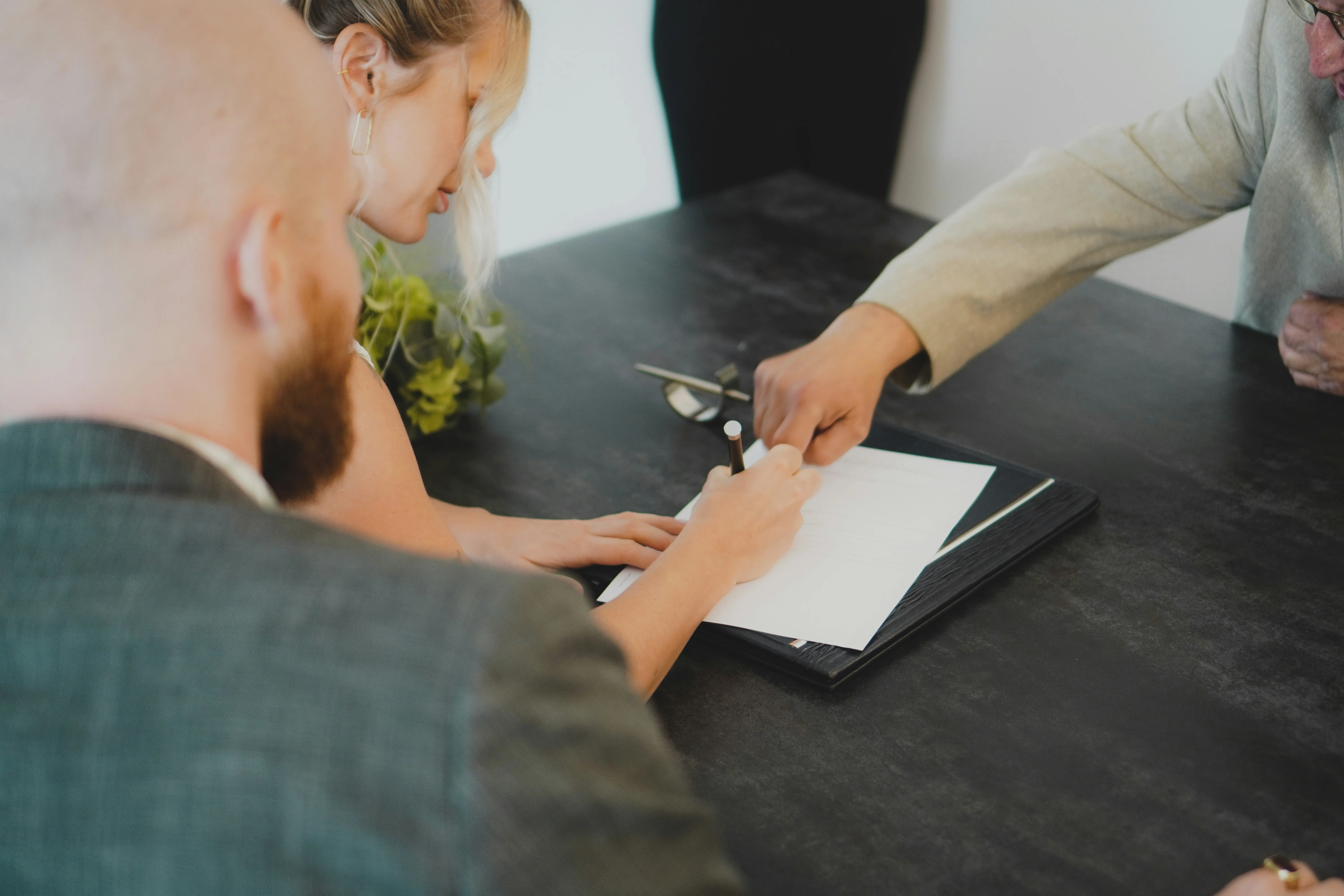 A man showing someone where to sign on a contract