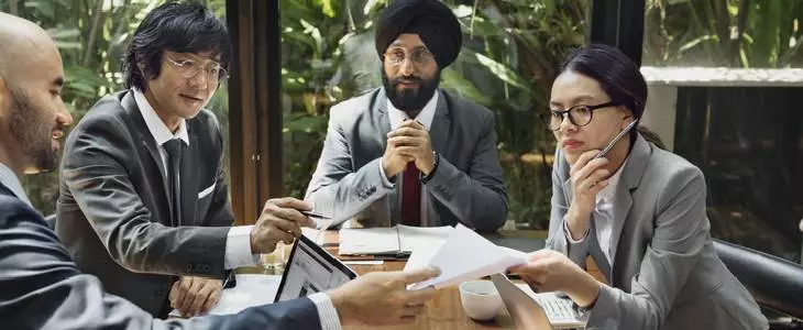 Ethnically diverse people having a business meeting in an office room