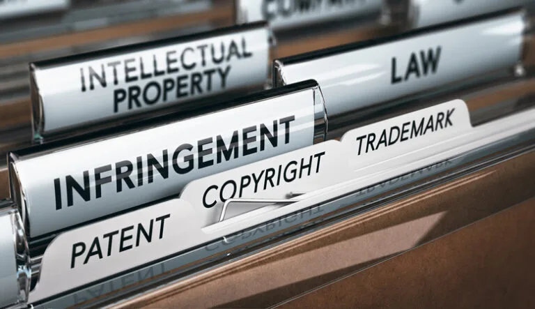 A filing cabinet drawer with file tabs labeled "INTELLECTUAL PROPERTY," "INFRINGEMENT," "COPYRIGHT," and "TRADEMARK."