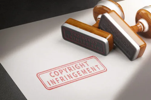 A rubber stamp on a document that reads "COPYRIGHT INFRINGEMENT."